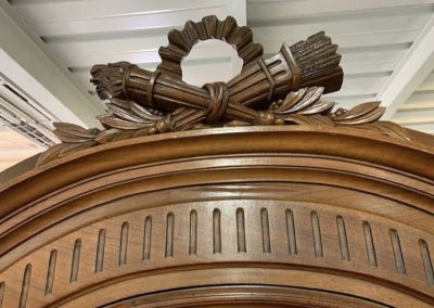Ornate wooden feature on cabinet.