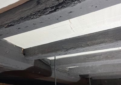 old wooden beams on ceiling with a dark wood stain